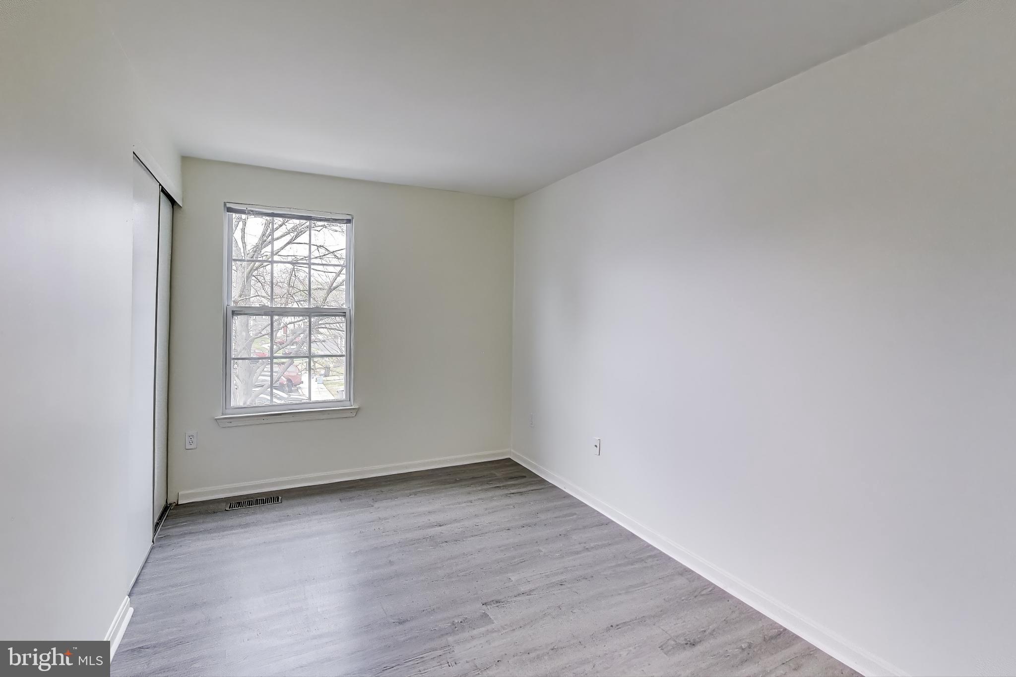 16 Tabiona Court Silver Spring, MD 20906 - Photo 17 of 34 an empty room with wooden floor and windows