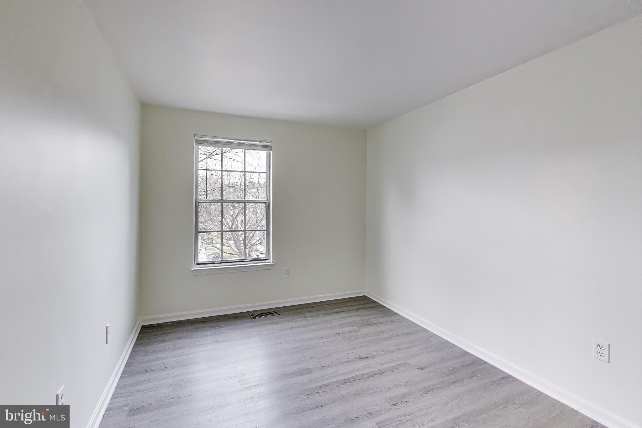 16 Tabiona Court Silver Spring, MD 20906 - Photo 20 of 34 an empty room with wooden floor and window