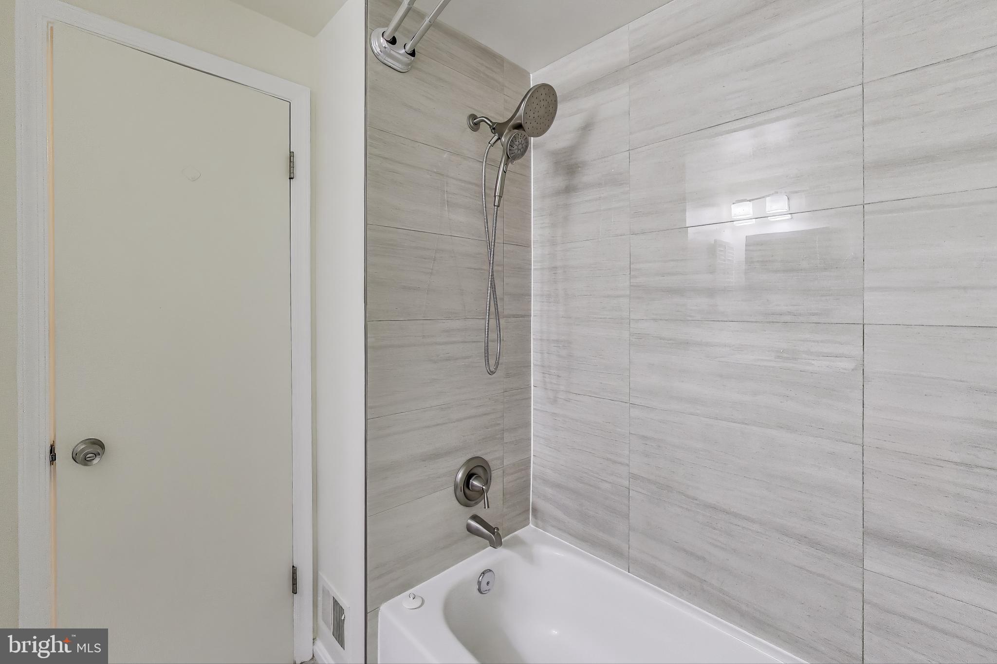 16 Tabiona Court Silver Spring, MD 20906 - Photo 23 of 34 a bathroom with a tub shower and a sink