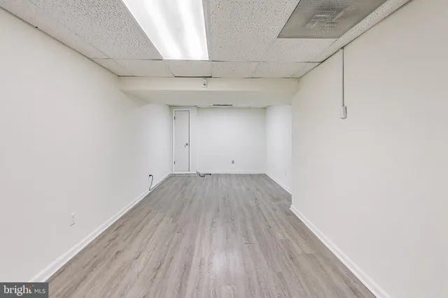 a view of a room with wooden floor