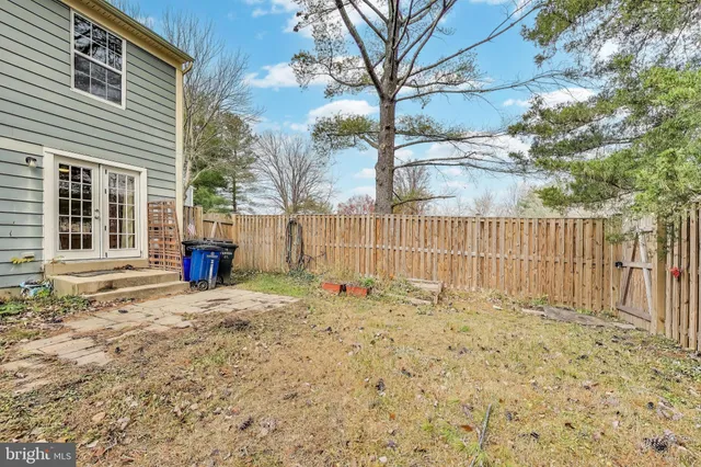 a white house that has tree in front of it