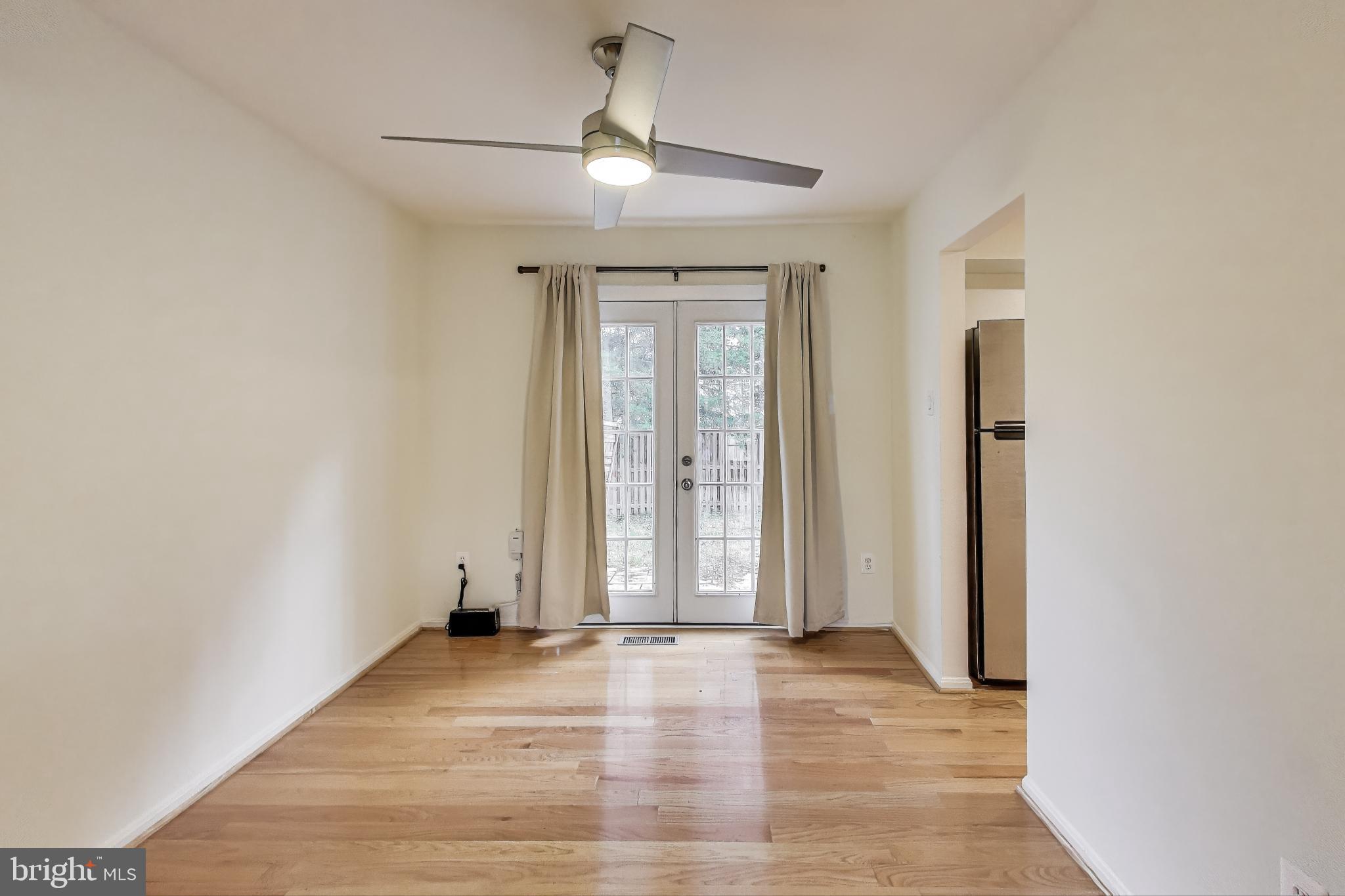 16 Tabiona Court Silver Spring, MD 20906 - Photo 7 of 34 an empty room with wooden floor and windows