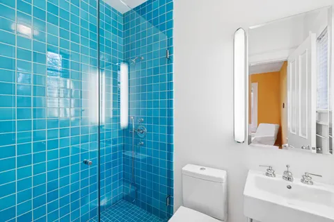 a bathroom with a shower a sink and a toilet