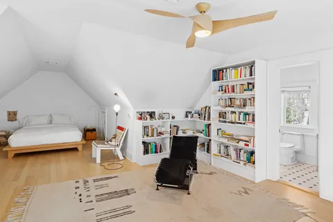 a living room with furniture and a book shelf