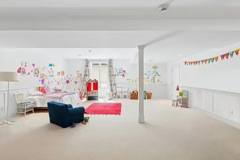 a playing room with toys and a couch