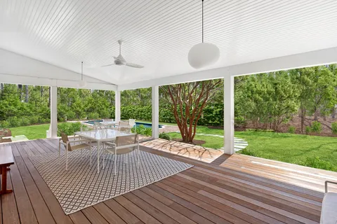 a view of a patio with chairs and floor to ceiling window
