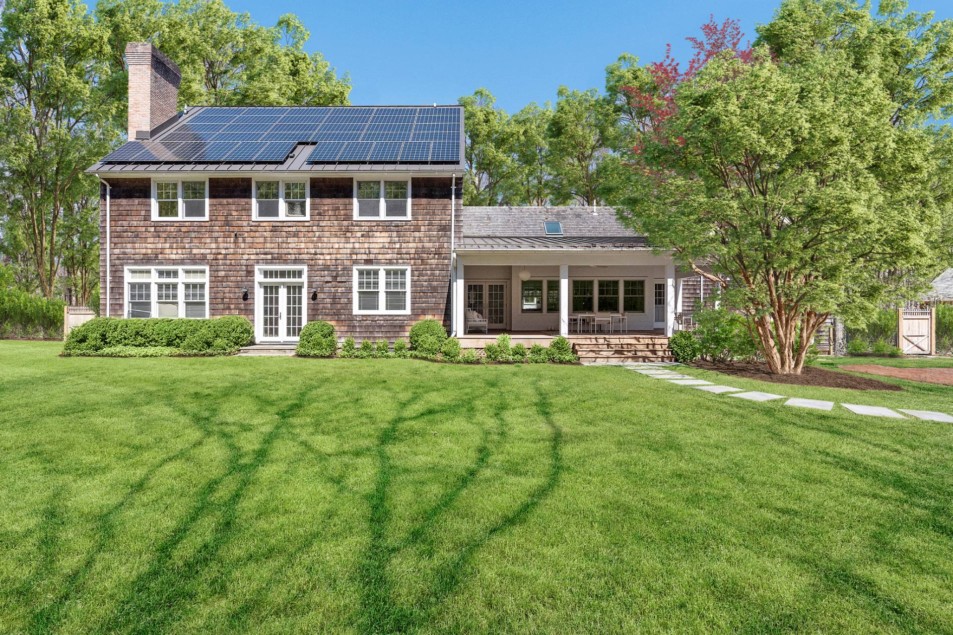 27 Gardiners Path Sag Harbor, NY 11963 - Photo 25 of 27 a front view of a house with a yard table and chairs
