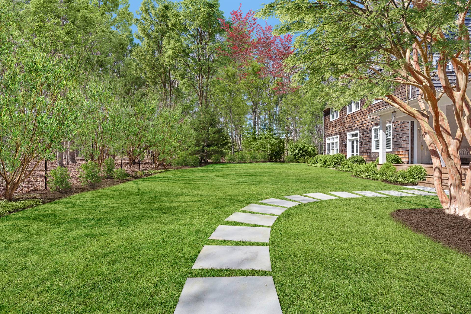 27 Gardiners Path Sag Harbor, NY 11963 - Photo 27 of 27 a view of a white house next to a yard with big trees
