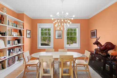a view of a dining room with furniture and a window