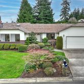 a view of a yard in front of a house with plants