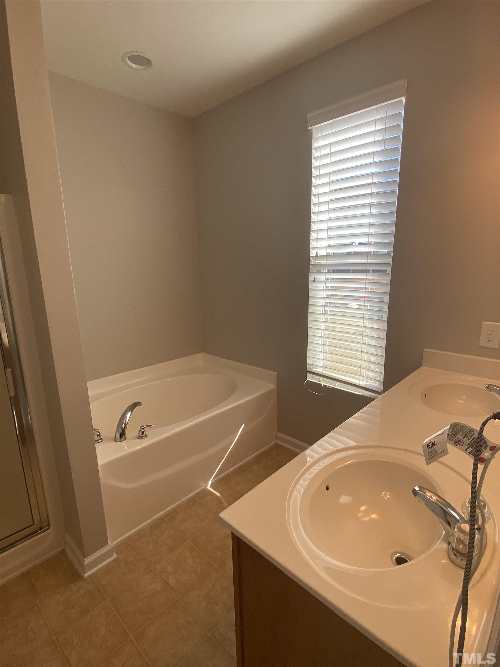 3532 Eastern Branch Road Raleigh, NC 27610 - Photo 27 of 36 a bathroom with a tub a sink and a window