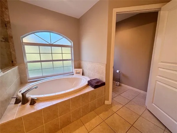 a bathroom with a tub and a shower