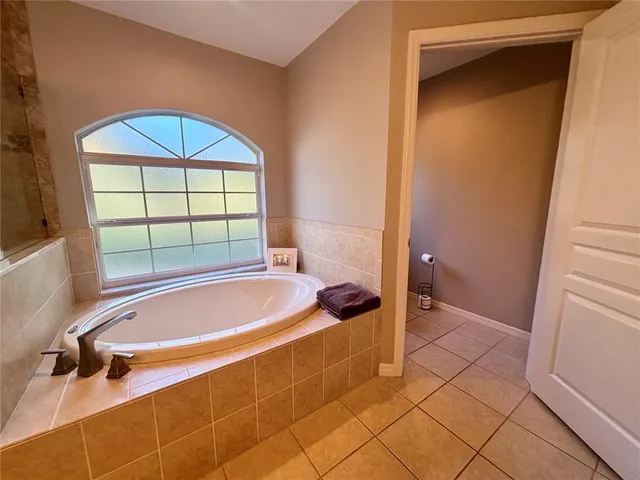 a bathroom with a tub and a shower