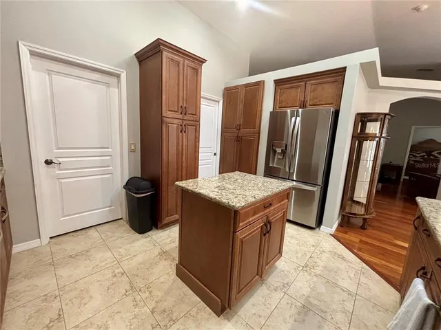 a kitchen with stainless steel appliances granite countertop a refrigerator and a stove