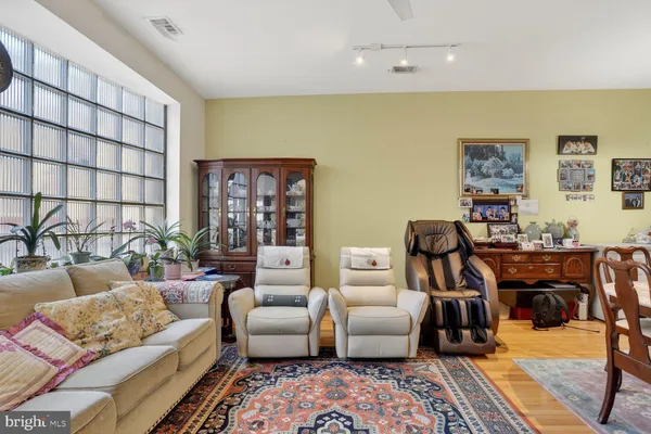 a bedroom with a bed a couch and dresser