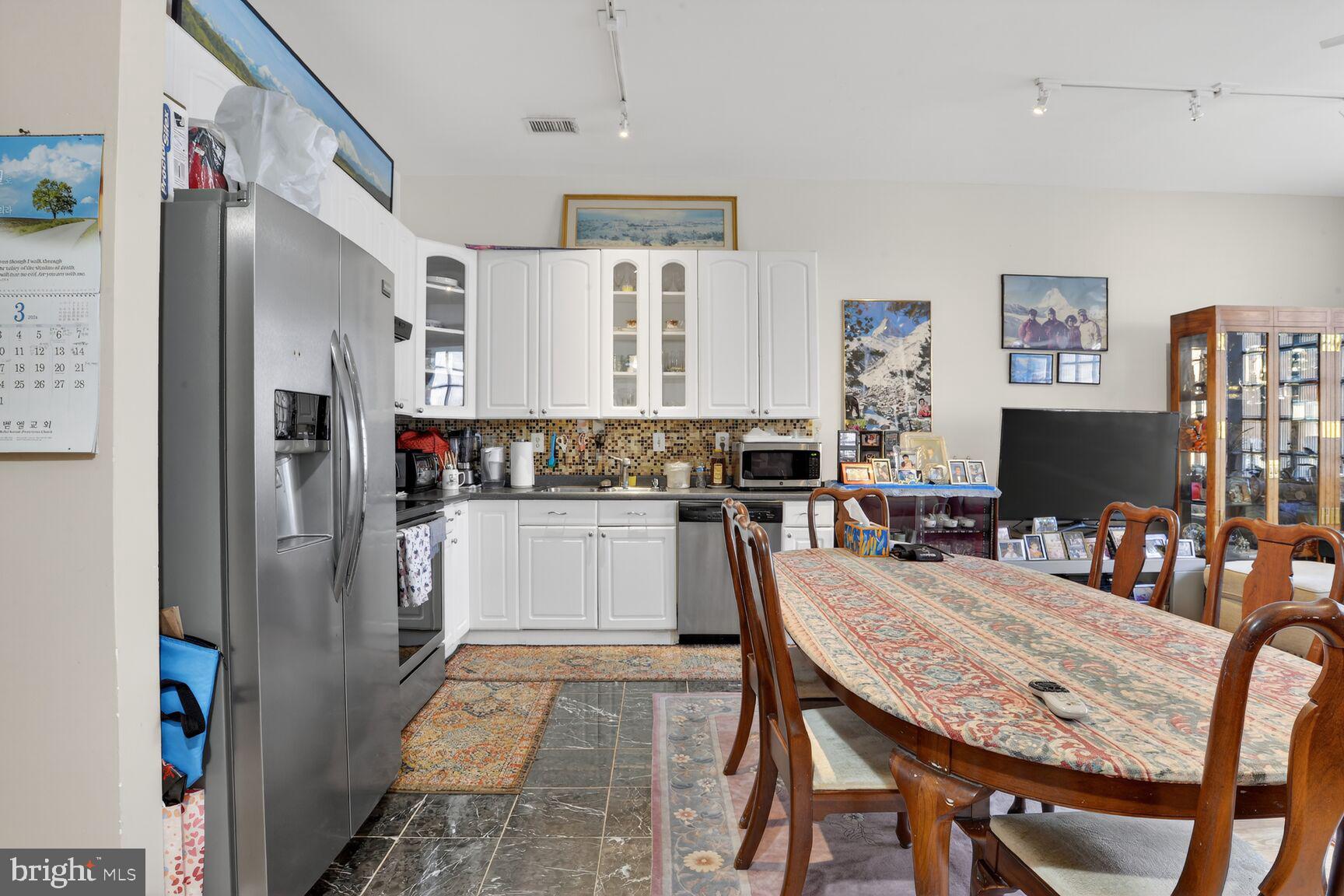 112 West Lexington Street Baltimore, MD 21201 - Photo 8 of 22 a kitchen with stainless steel appliances granite countertop a refrigerator and microwave
