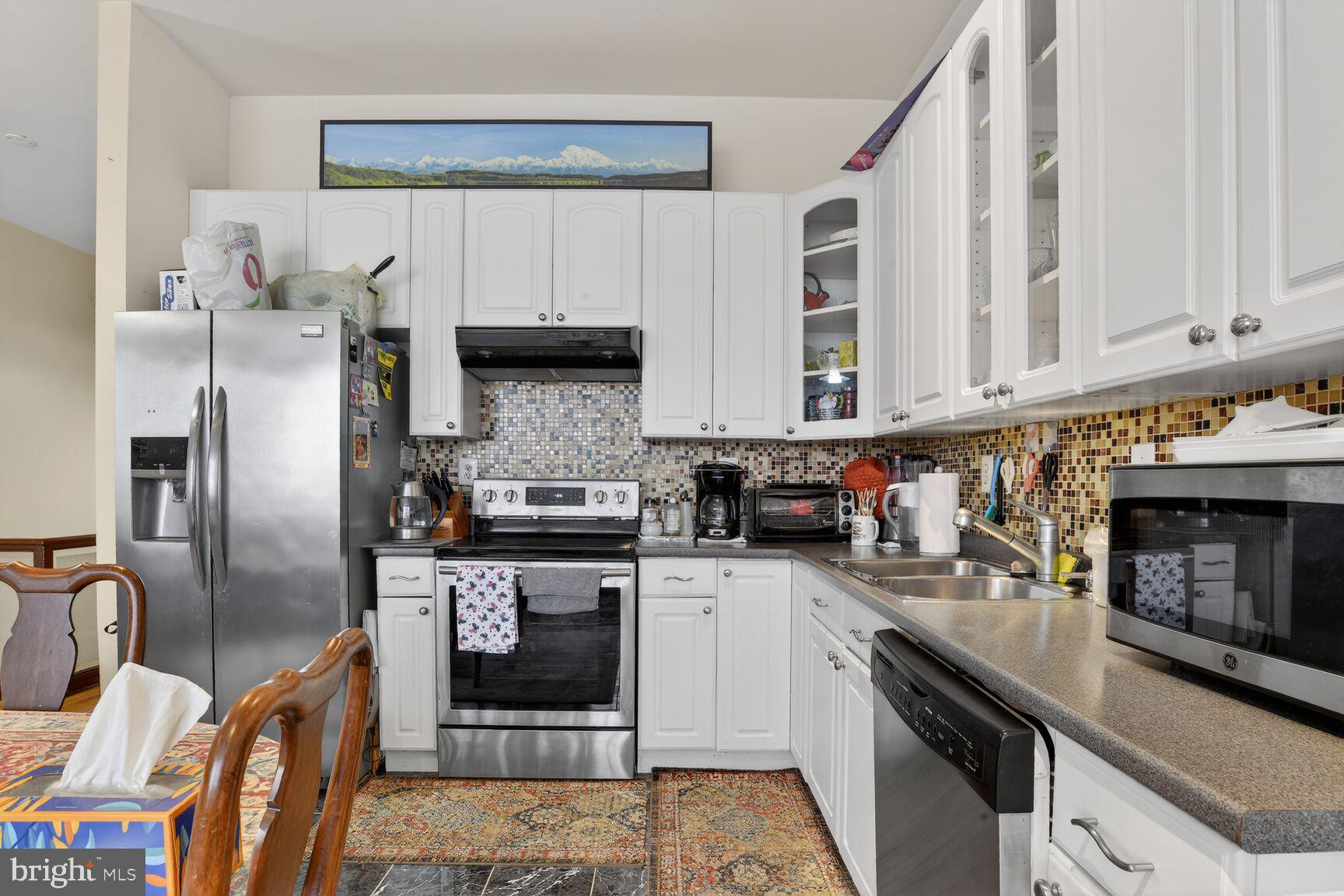 112 West Lexington Street Baltimore, MD 21201 - Photo 10 of 22 a kitchen with stainless steel appliances granite countertop a stove a sink and a refrigerator