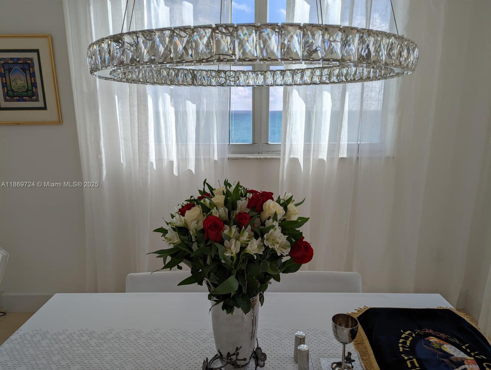 9273 Collins Avenue, Unit 1004 Surfside, FL 33154 - Photo 13 of 27 a vase of flowers sitting on a table