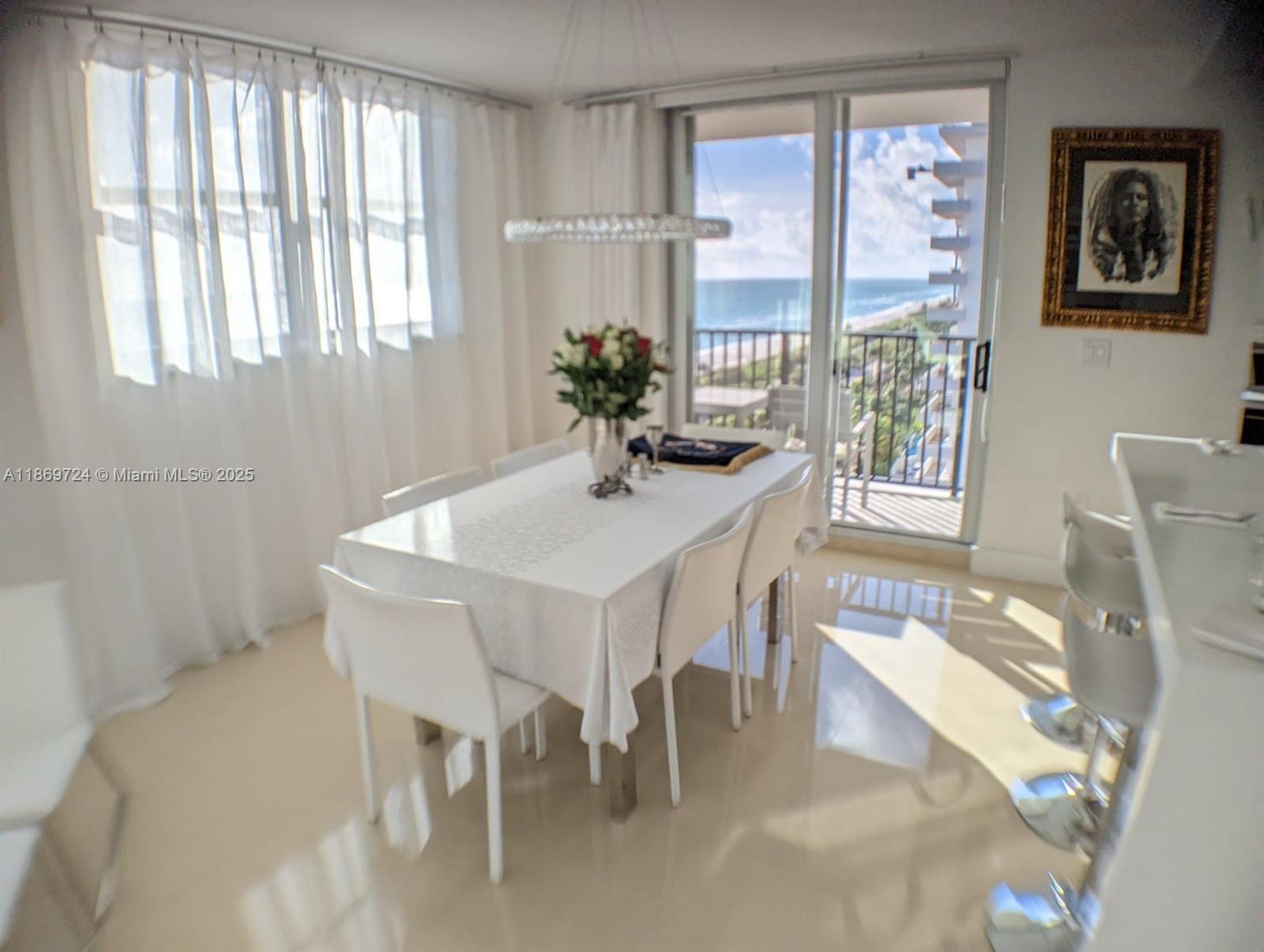 9273 Collins Avenue, Unit 1004 Surfside, FL 33154 - Photo 14 of 27 a dining room with furniture and window