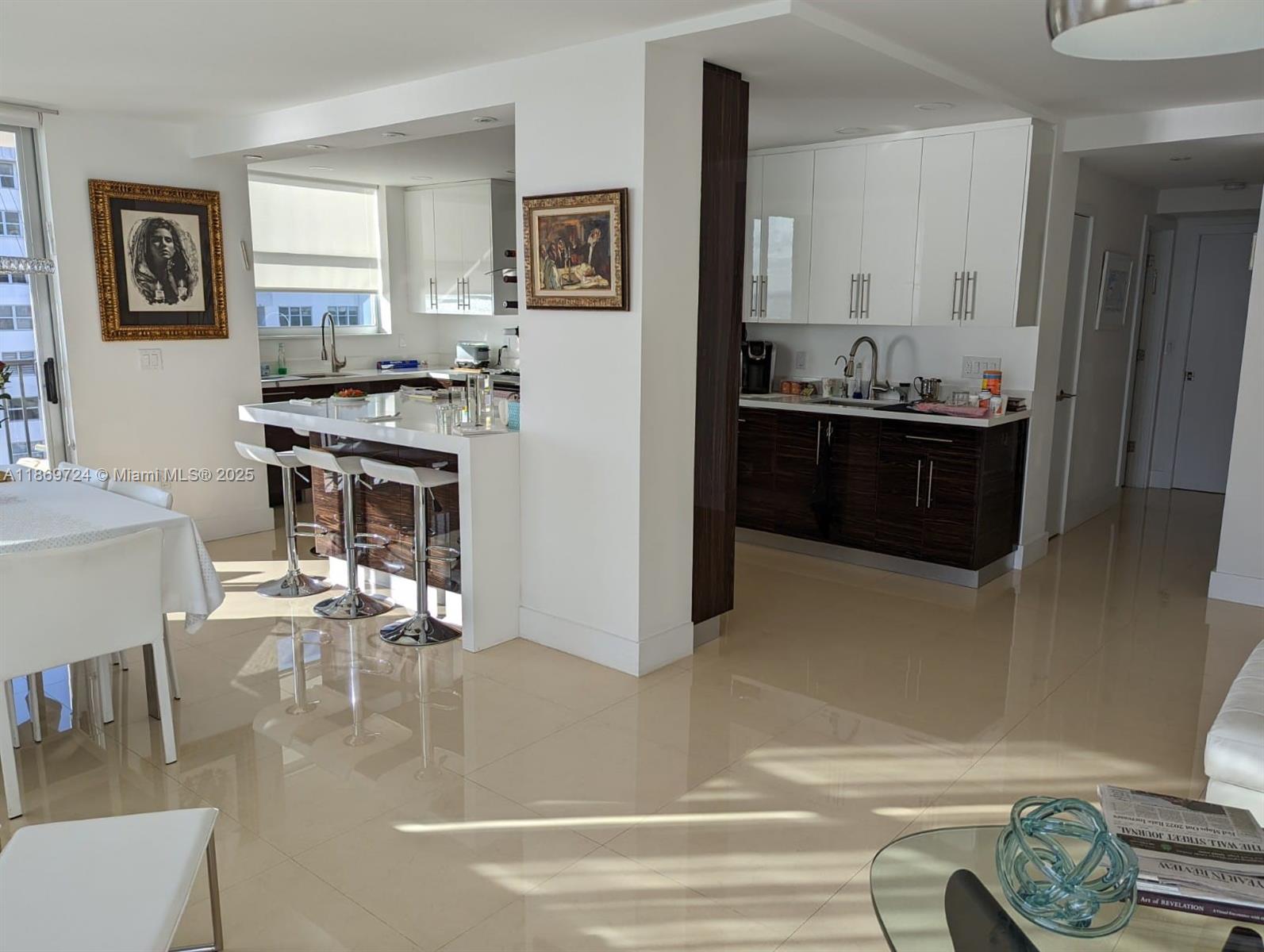 9273 Collins Avenue, Unit 1004 Surfside, FL 33154 - Photo 15 of 27 a kitchen with a refrigerator and a stove top oven