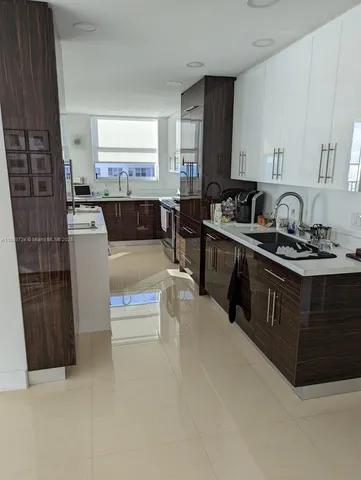 a large white kitchen with a large window