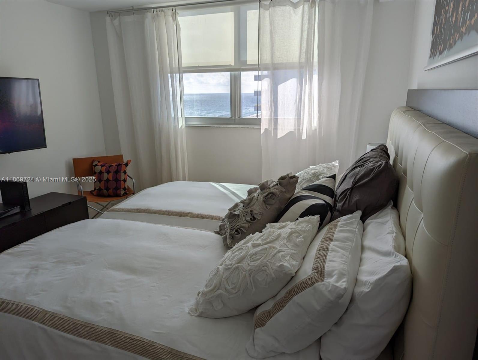 9273 Collins Avenue, Unit 1004 Surfside, FL 33154 - Photo 22 of 27 a bedroom with a bed and a window
