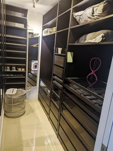 a bathroom with a sink a toilet a mirror and shower