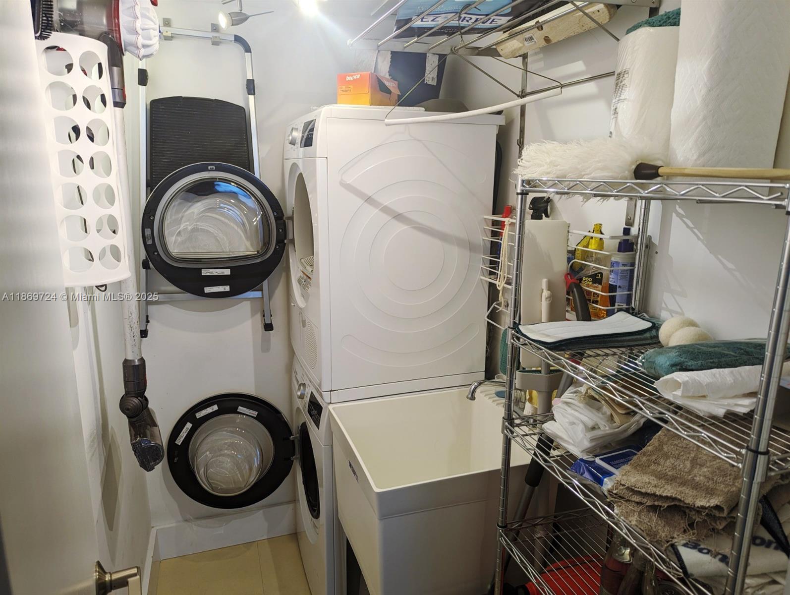 9273 Collins Avenue, Unit 1004 Surfside, FL 33154 - Photo 27 of 27 a utility room with dryer and washer