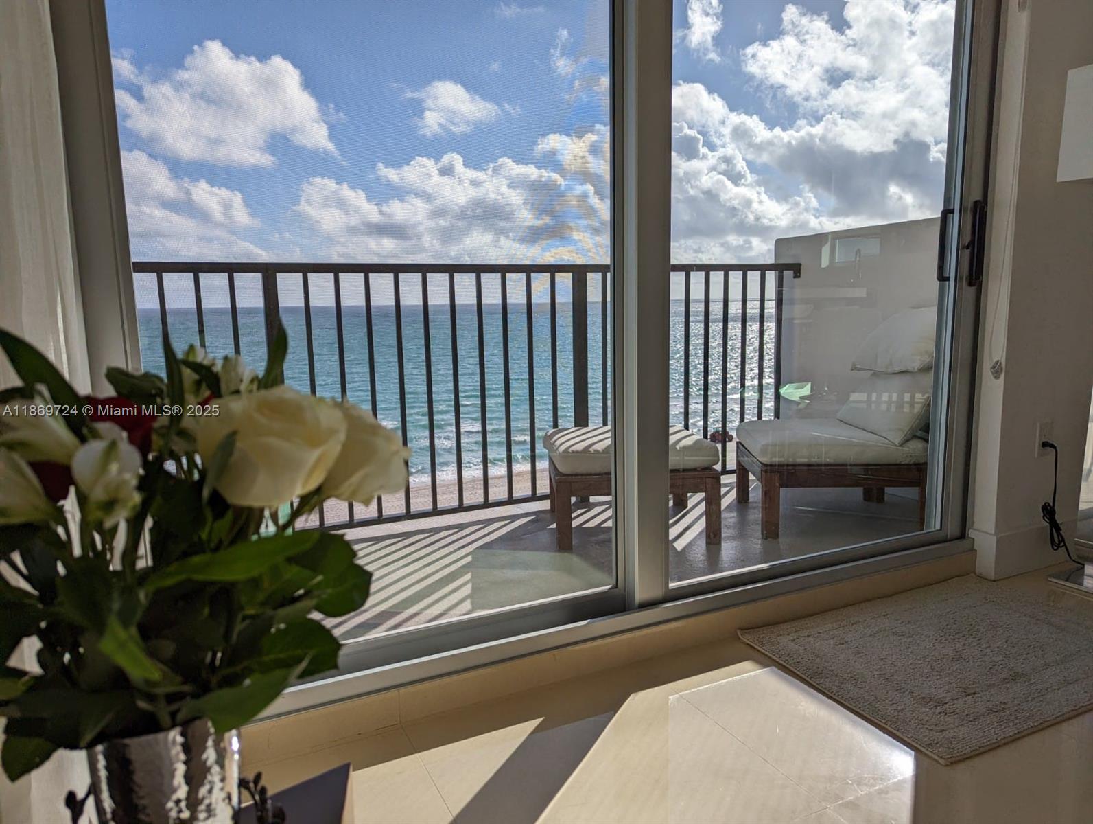 9273 Collins Avenue, Unit 1004 Surfside, FL 33154 - Photo 5 of 27 a view of a balcony with chairs