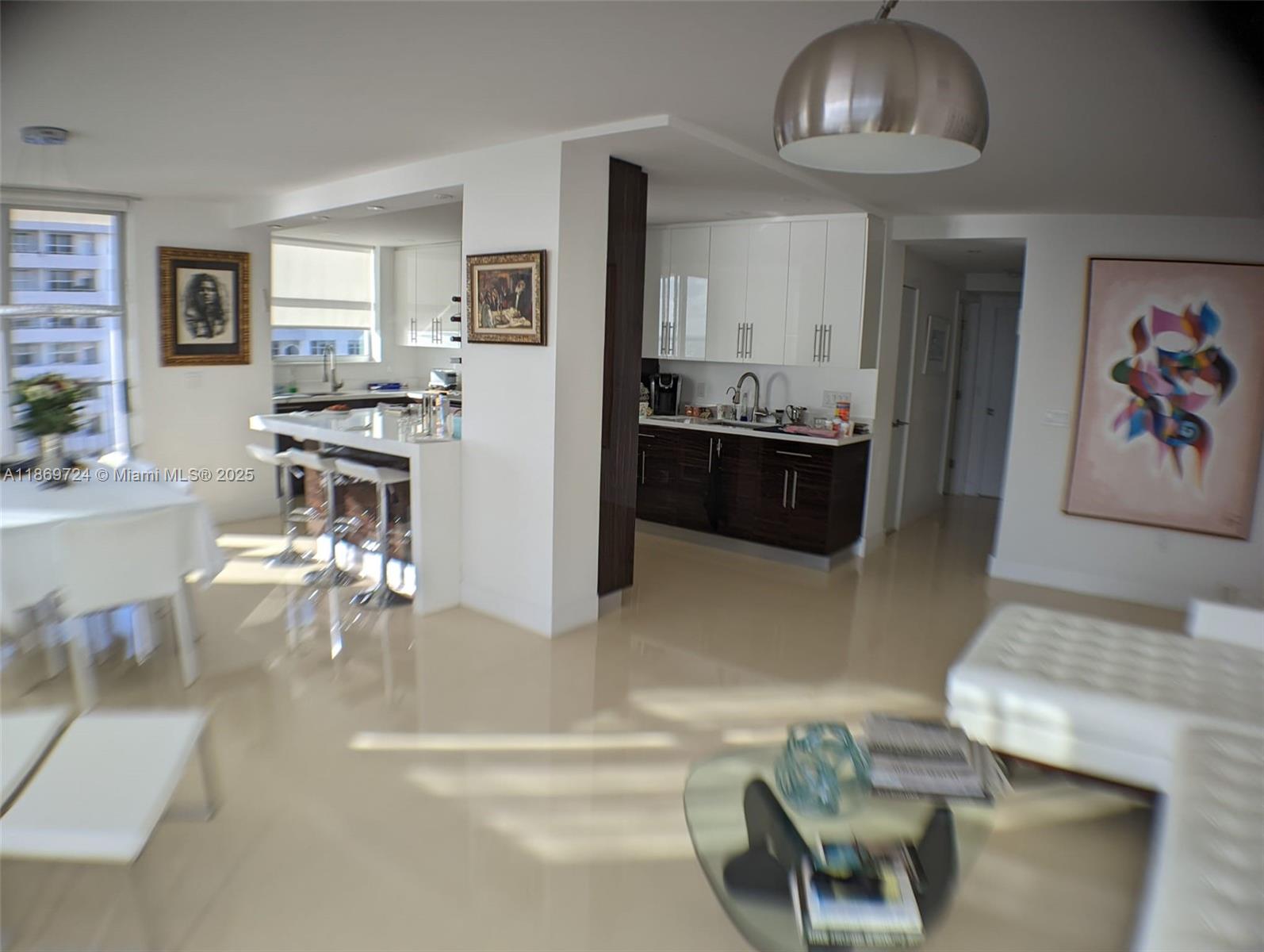 9273 Collins Avenue, Unit 1004 Surfside, FL 33154 - Photo 6 of 27 a living room with furniture and kitchen view