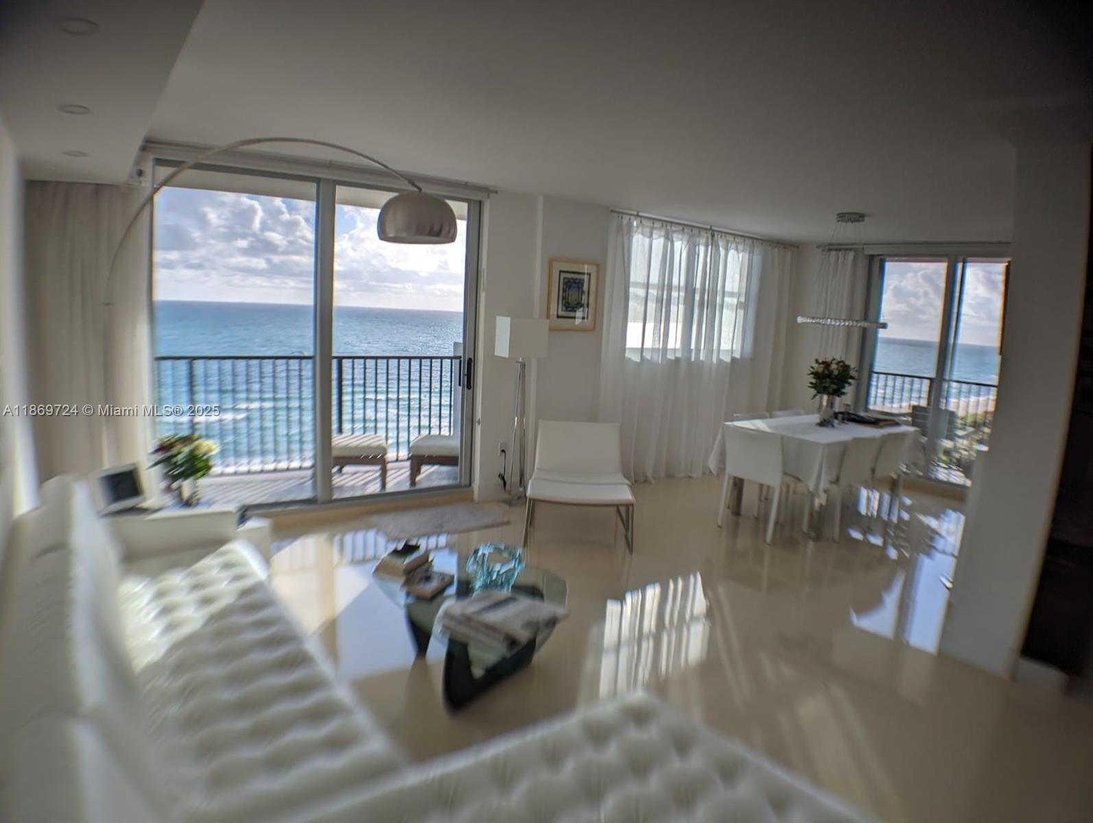 9273 Collins Avenue, Unit 1004 Surfside, FL 33154 - Photo 8 of 27 a living room with furniture and a large window