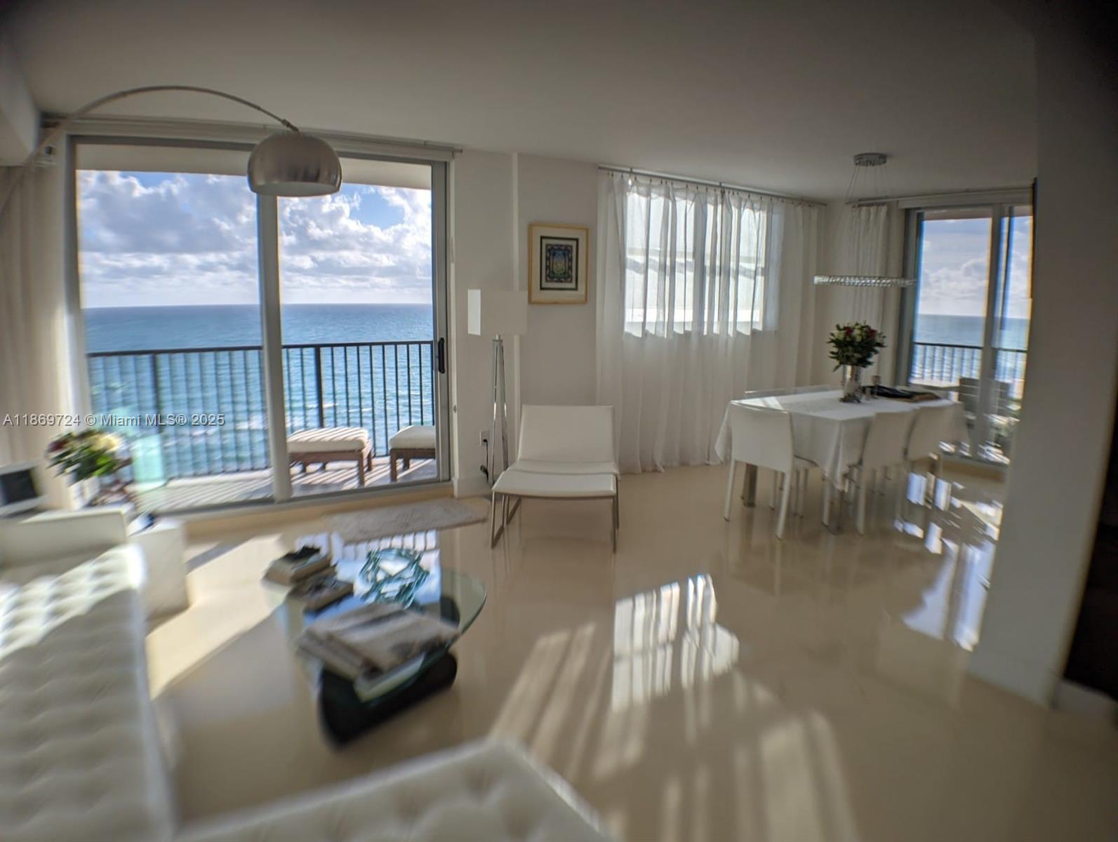 9273 Collins Avenue, Unit 1004 Surfside, FL 33154 - Photo 9 of 27 a living room with furniture and a large window