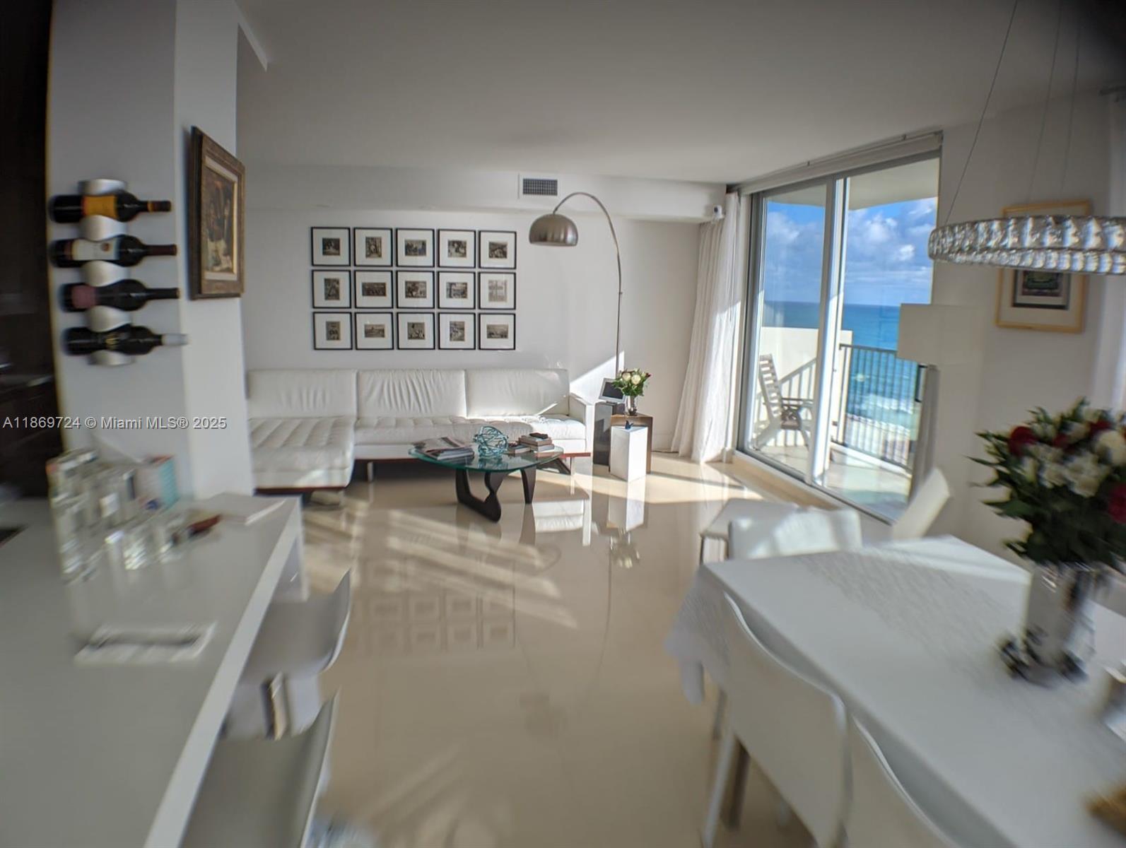 9273 Collins Avenue, Unit 1004 Surfside, FL 33154 - Photo 10 of 27 a living room with furniture and a potted plant