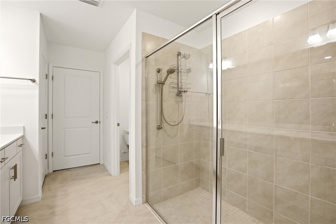 3751 Pebblebrook Ridge Court, Unit 101 Fort Myers, FL 33905 - Photo 31 of 48 a bathroom with a glass shower door
