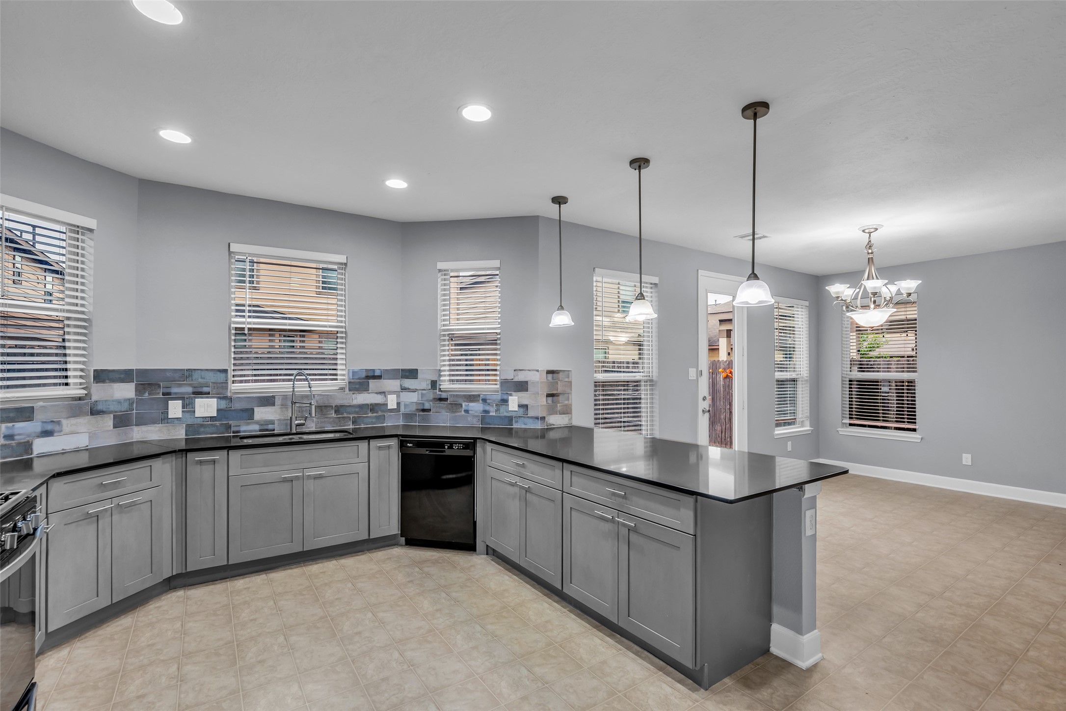 2707 Volute Houston, TX 77038 - Photo 11 of 28 A breakfast bar is included, highlighted by pendant drop lights overhead that add focused illumination and style.
