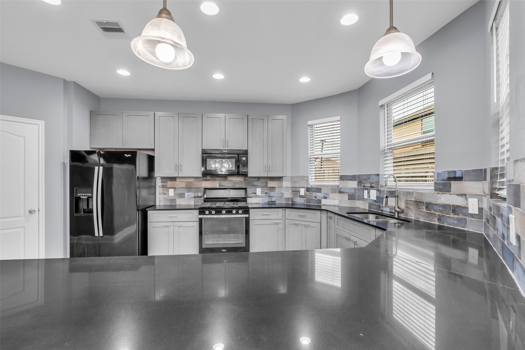 2707 Volute Houston, TX 77038 - Photo 13 of 28 Granite countertops offer generous workspace for meal preparation and daily kitchen tasks.
