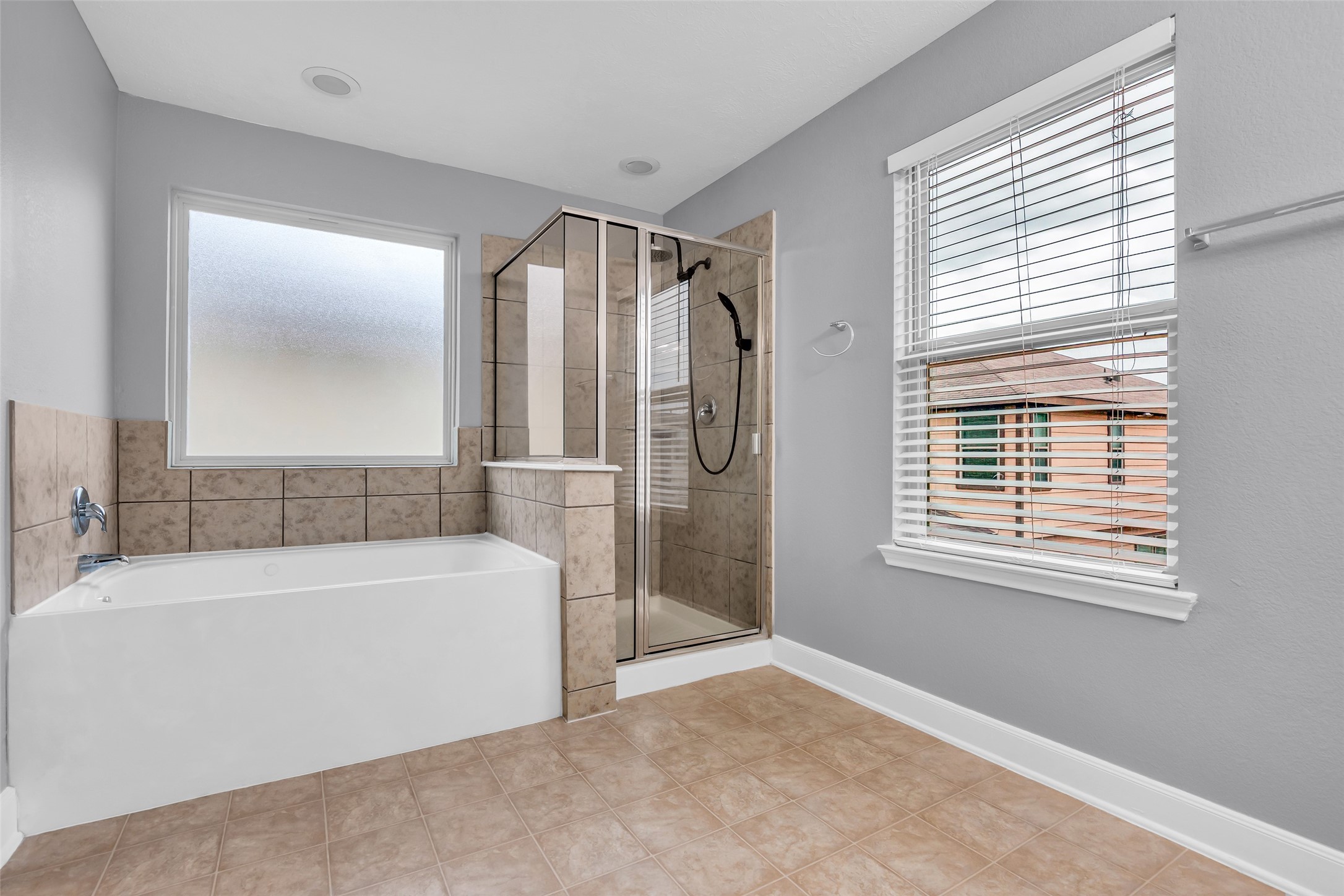 2707 Volute Houston, TX 77038 - Photo 19 of 28 The primary bathroom includes a separate soaking tub and a shower, providing distinct bathing options within the space.