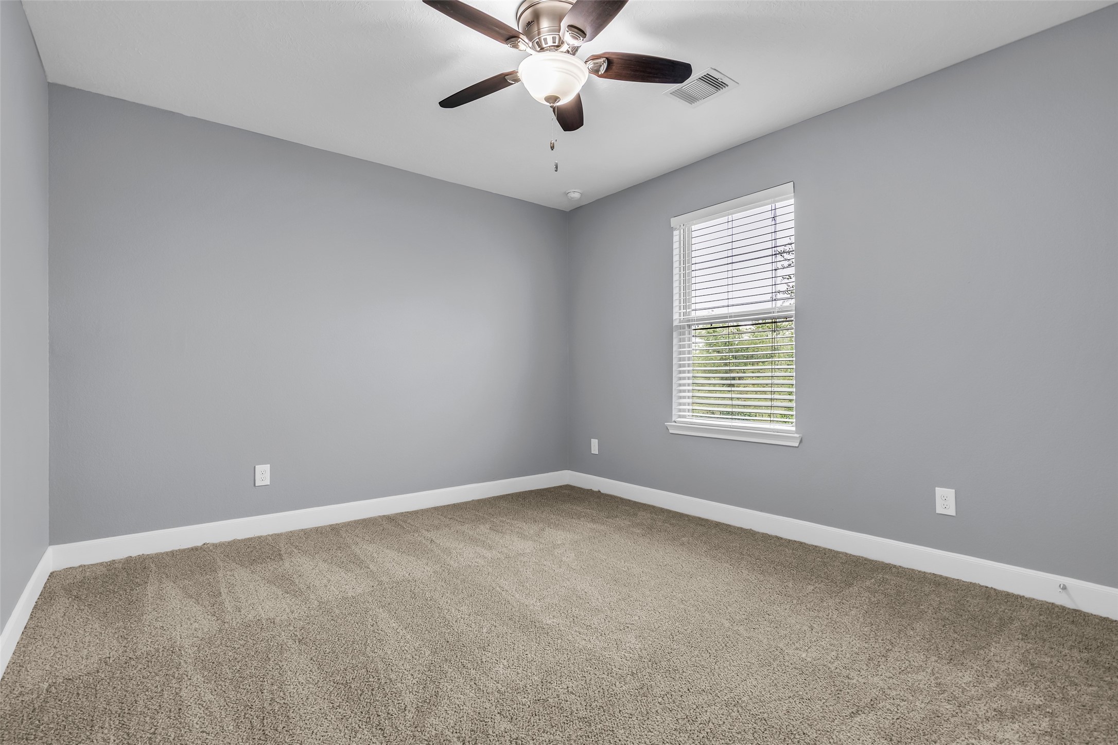 2707 Volute Houston, TX 77038 - Photo 21 of 28 Secondary bedroom overlooking the front lawn, featuring carpeted flooring.