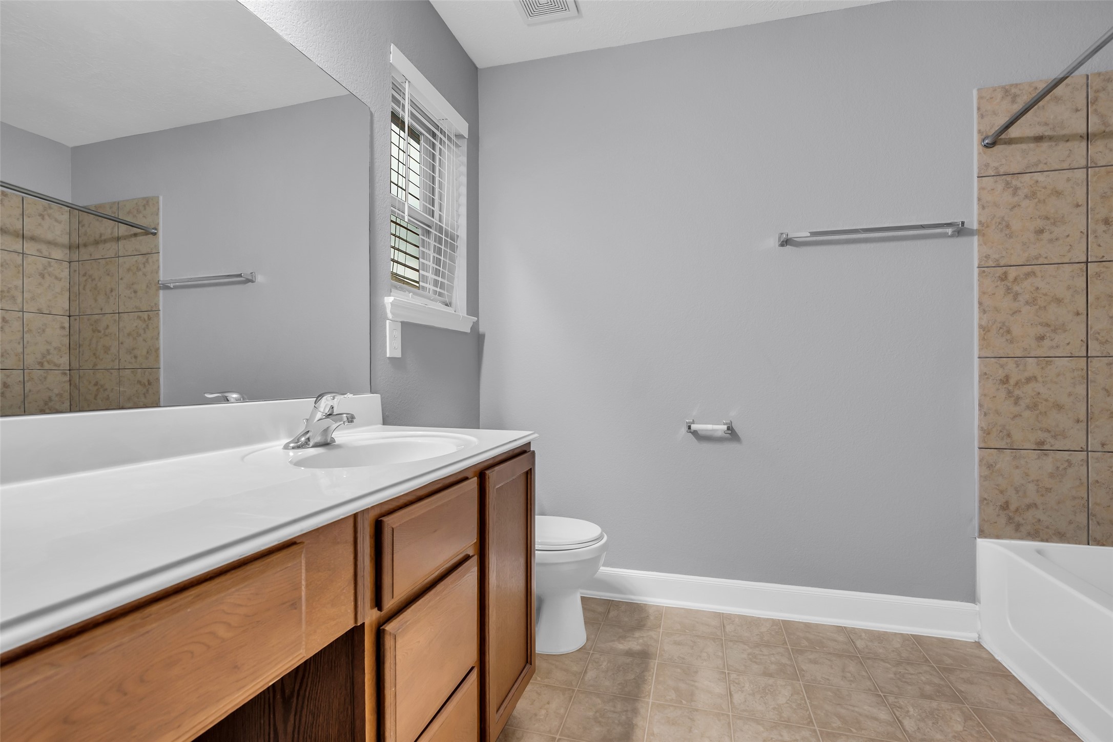 2707 Volute Houston, TX 77038 - Photo 23 of 28 Shared secondary bathroom featuring a tub and shower combination, along with a spacious vanity mirror and sink area.