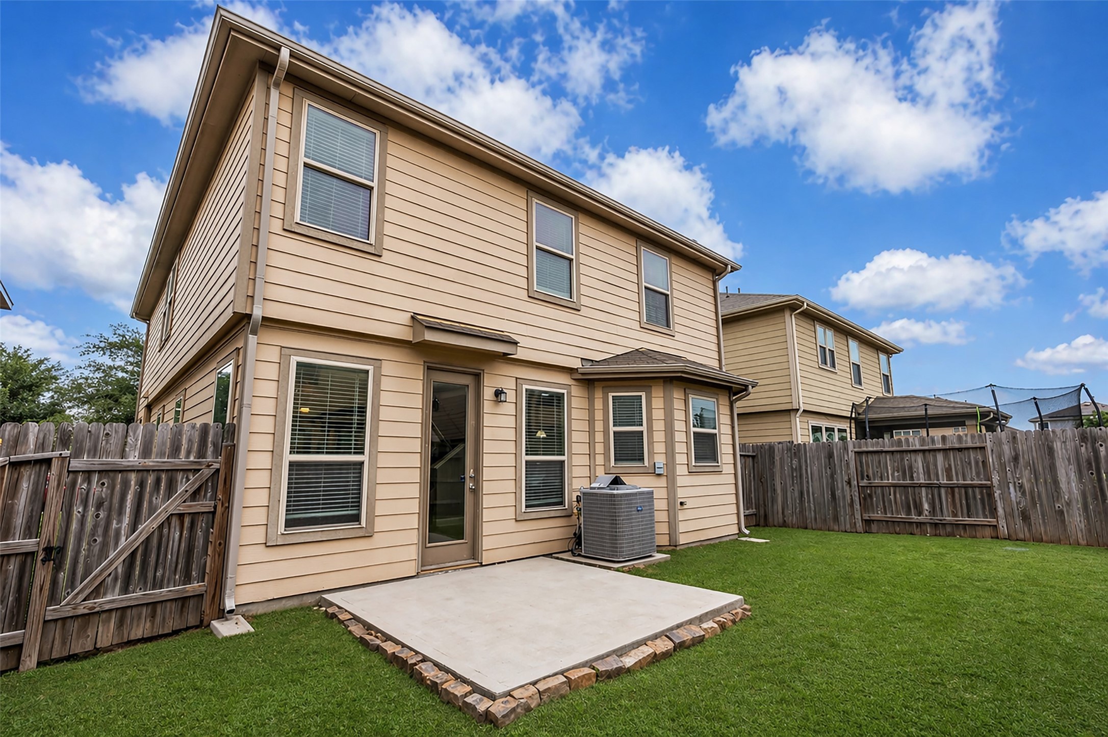 2707 Volute Houston, TX 77038 - Photo 24 of 28 View of the rear exterior of the home, featuring an open patio connected to the back door, providing an easy transition to outdoor space.