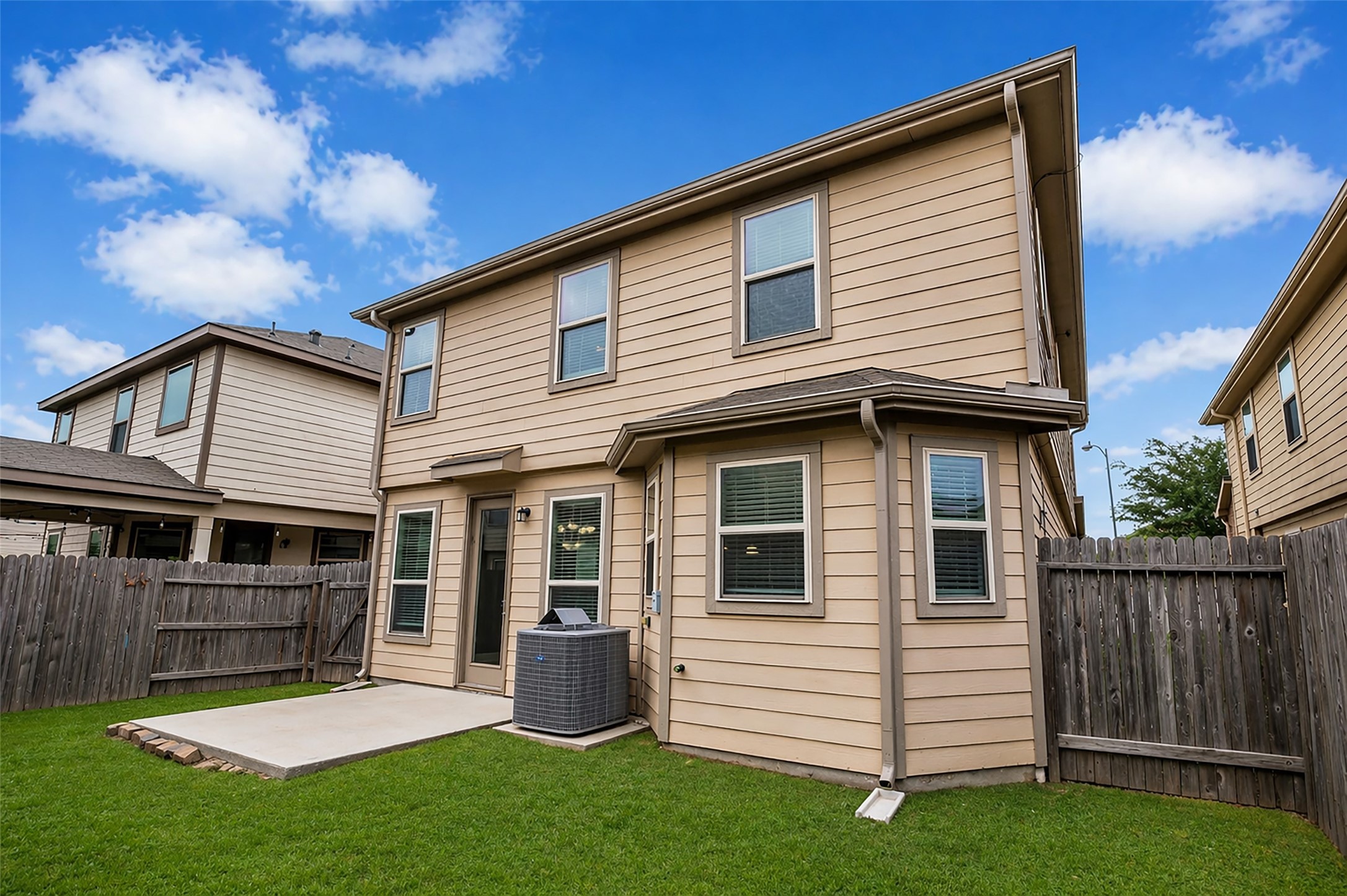 2707 Volute Houston, TX 77038 - Photo 25 of 28 The backyard is fully enclosed by a wooden fence, providing a defined outdoor space connected to the home’s rear patio.