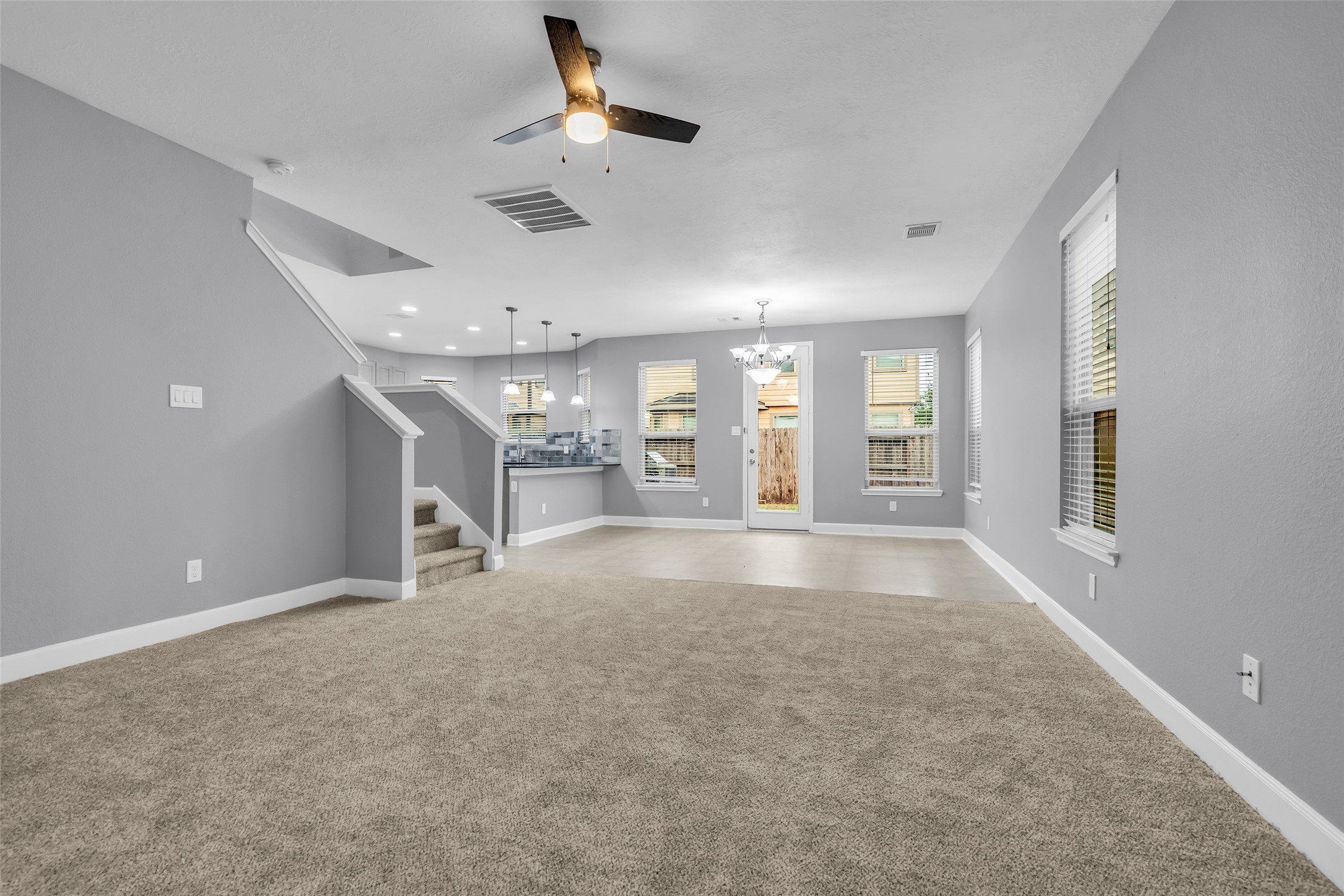 2707 Volute Houston, TX 77038 - Photo 6 of 28 View from the foyer extending to the dining area, which features tiled flooring and ample natural light from its glass windows.
