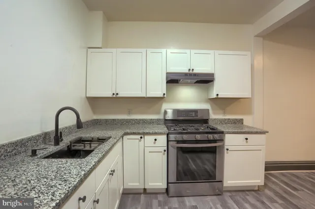 a kitchen with stainless steel appliances granite countertop a stove and a sink with granite countertops
