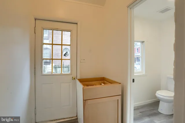 a bathroom with a toilet sink and a window