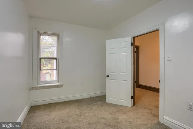 an empty room with windows and closet