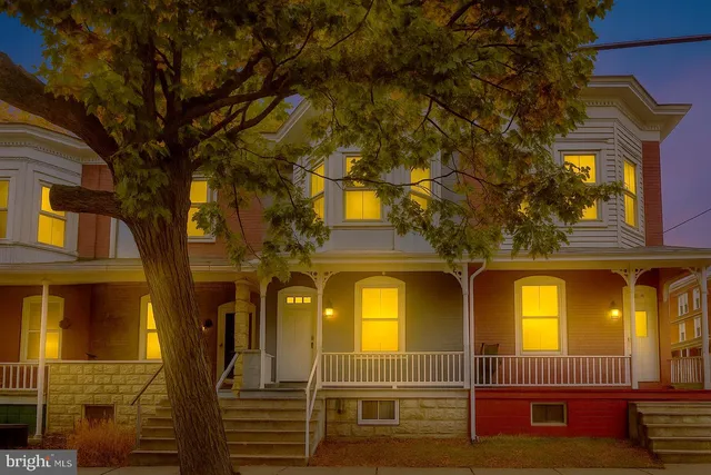 a view of a brick house with large windows