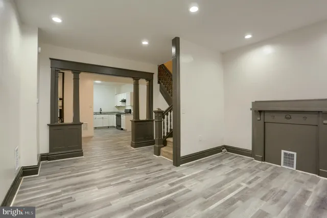 a view of a room with wooden floor and furniture