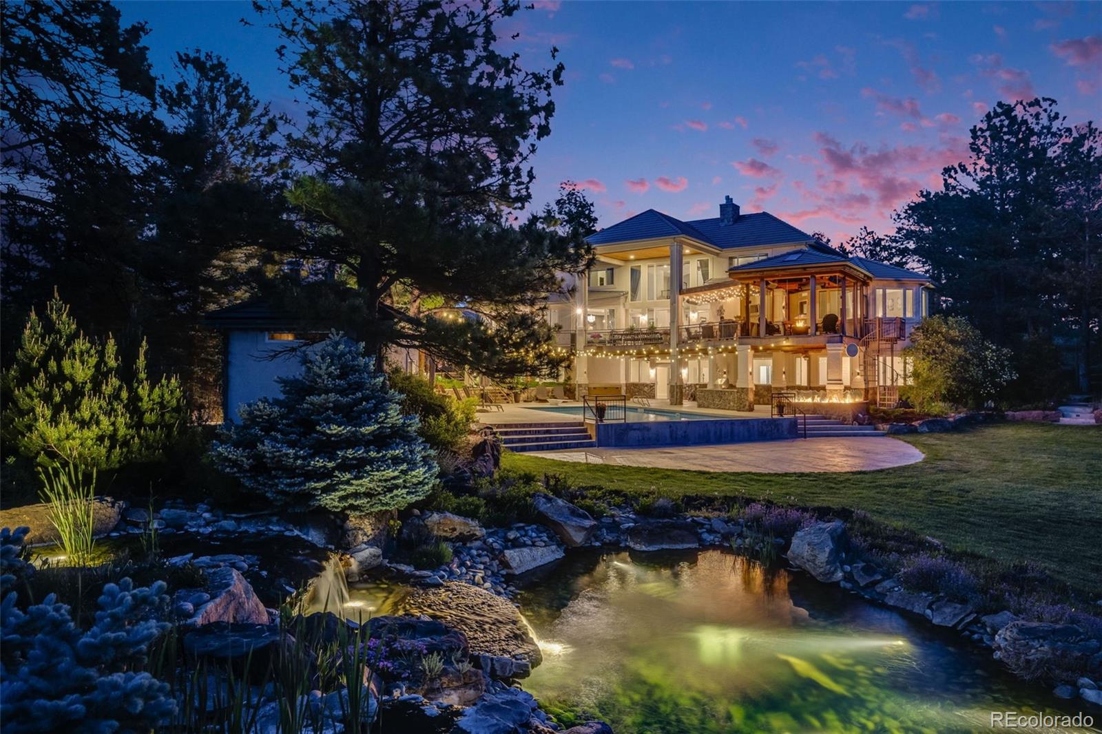a view of a house with swimming pool and a yard