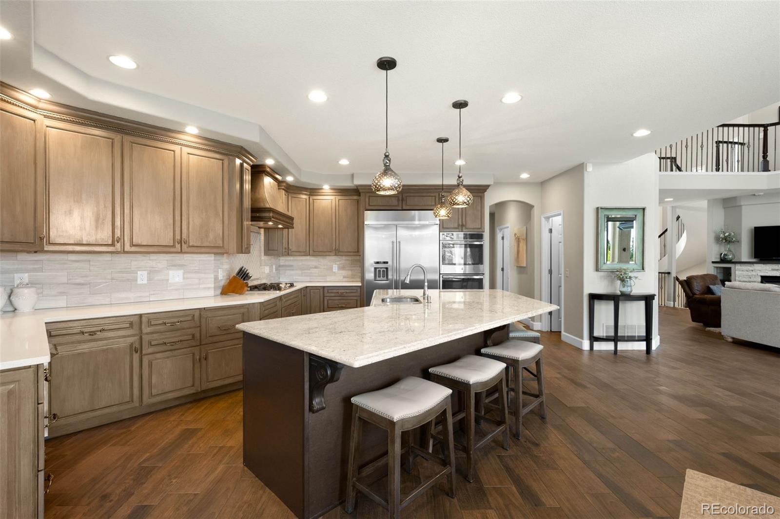 10914 Remmick Ridge Road Parker, CO 80134 - Photo 11 of 47 a large kitchen with a table and chairs