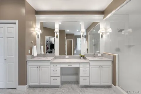 a bathroom with a granite countertop sink double and mirror